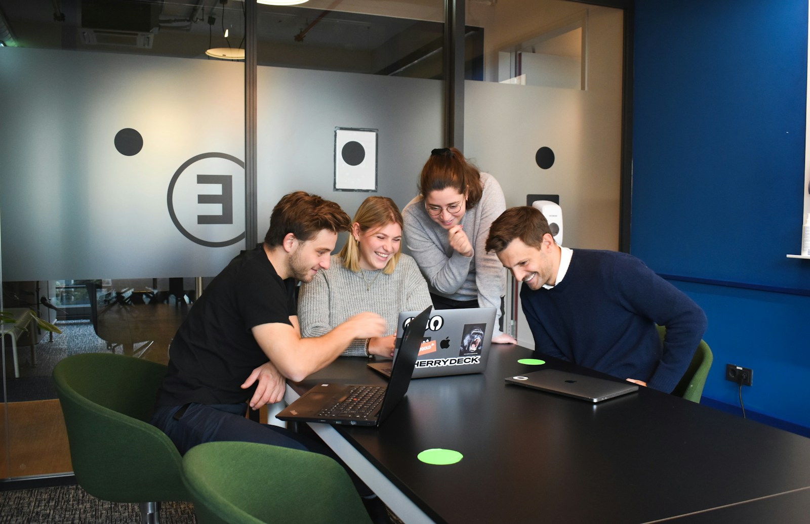 a couple of men sitting at a desk in an office